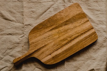 Clean chopping board with kosher salt and lemons