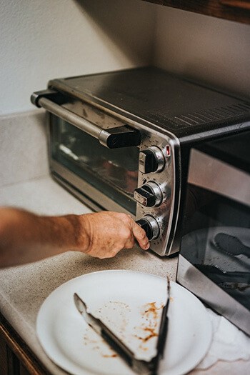 Clean your toaster using an old toothbrush