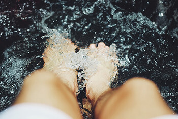 Soothe feet by soaking them in warm water with baking soda