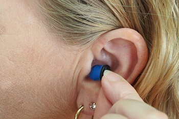 Using hearing aids or ear plugs can also cause blocked ears