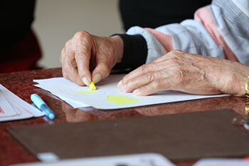 hands using crayons