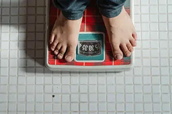 person in weighing scale