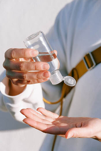 person holding a hand sanitizer