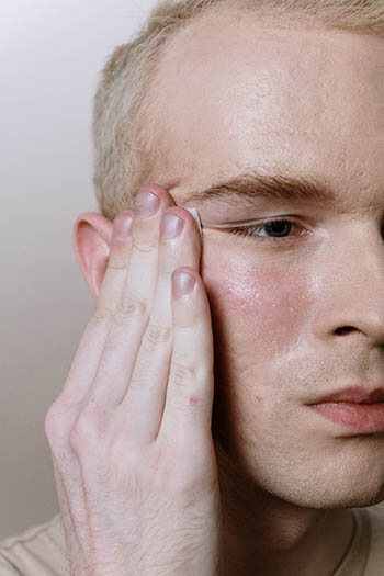 person adding facial cleanser