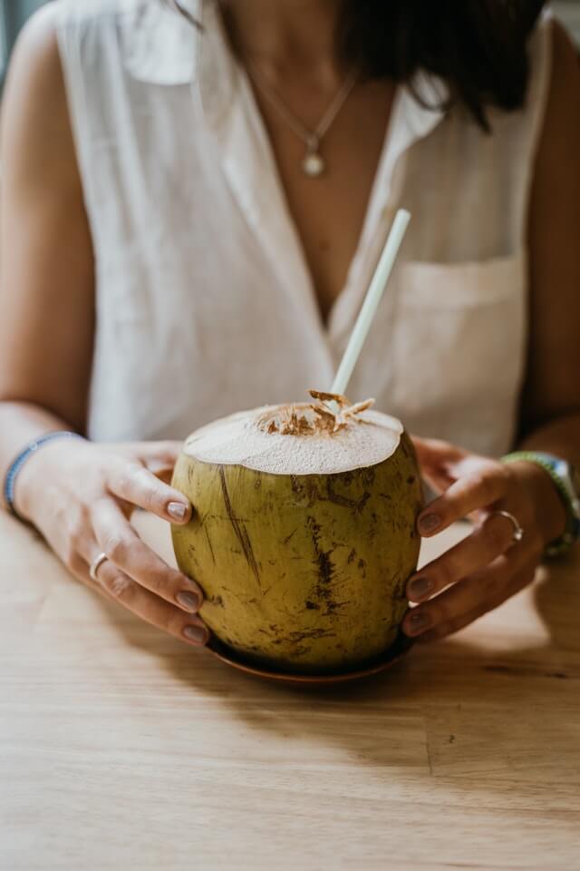 Person holding a coconut