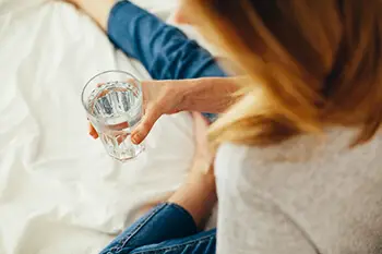 person with a cup of water in hand