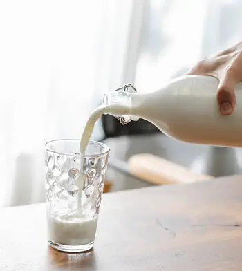 pouring milk into a glass