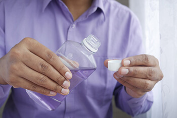 person holding hydrogen peroxide rinse