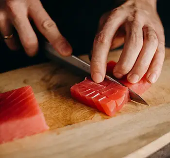 person cutting tuna