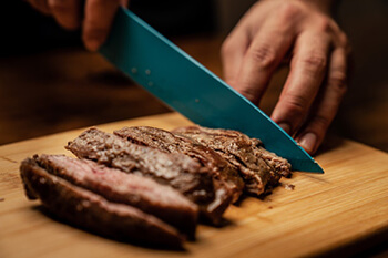 person cutting meat