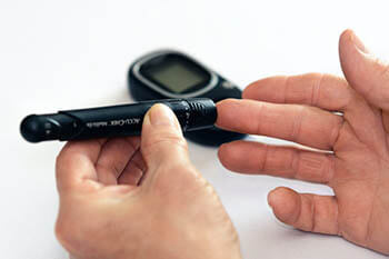 person getting their blood sugar tested