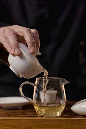 pouring tea on a cup